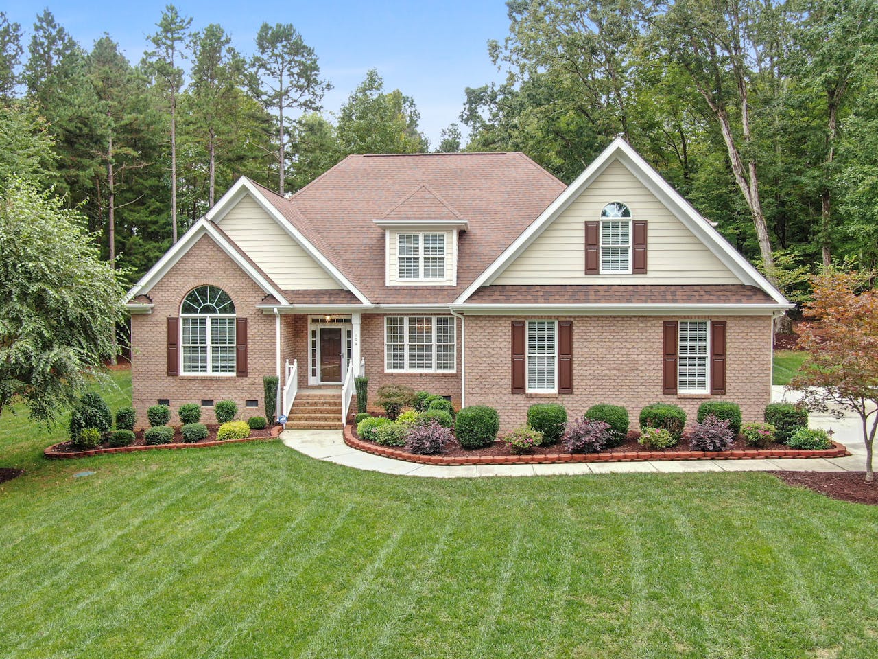 Beautiful brick house with manicured lawn in Timberlake, NC.